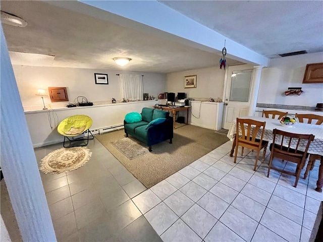 living room featuring light tile patterned floors, visible vents, and decorative columns