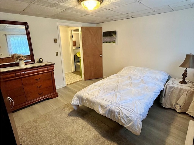 bedroom featuring baseboards and light wood-type flooring