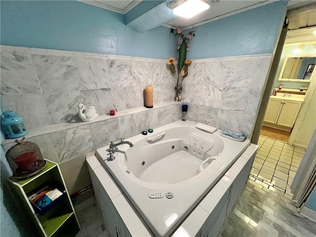 full bath with vanity, tile walls, and a whirlpool tub