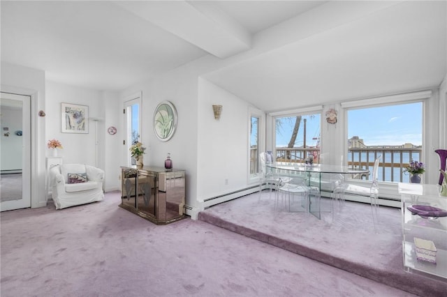 carpeted living room with beam ceiling and a water view