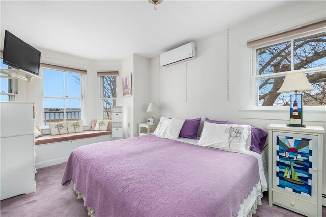 carpeted bedroom with a wall mounted air conditioner and multiple windows