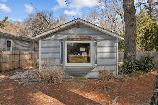 view of outbuilding with fence