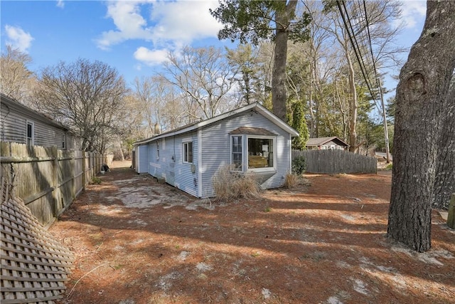 view of outbuilding with fence