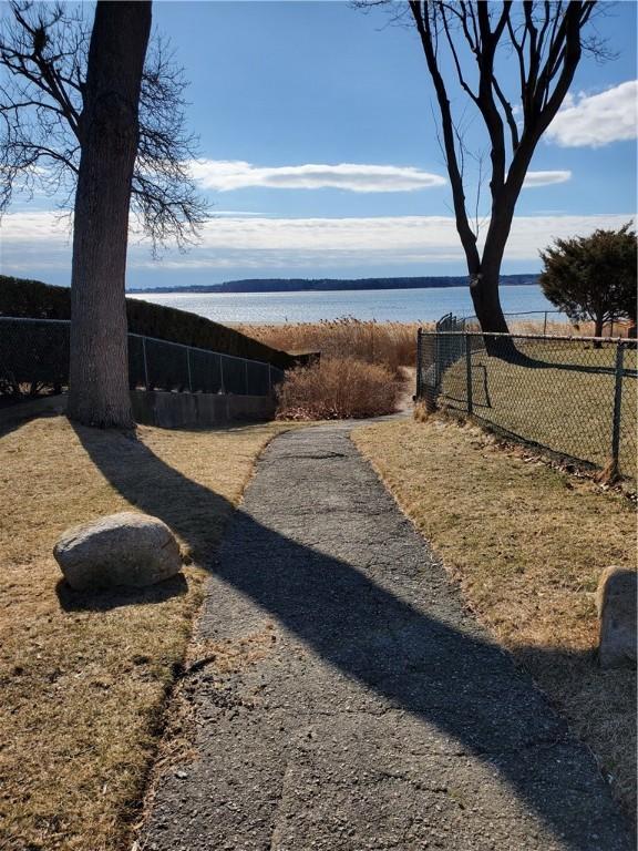 view of yard with fence and a water view