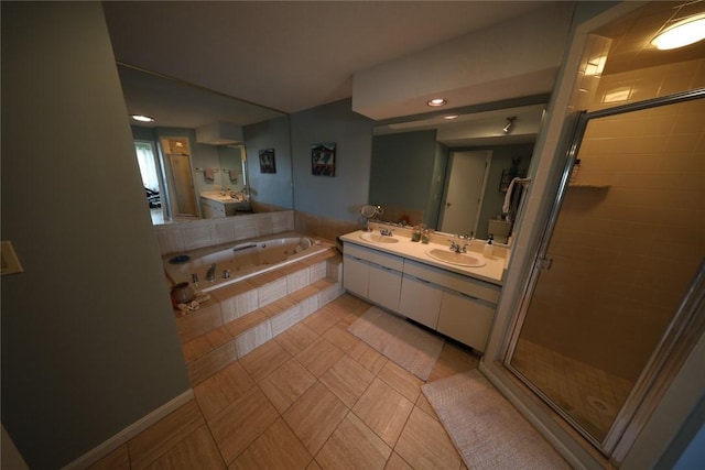 full bathroom featuring a sink, a garden tub, a stall shower, and double vanity