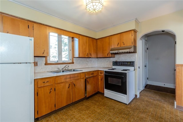 kitchen featuring freestanding refrigerator, a sink, light countertops, under cabinet range hood, and range with electric stovetop