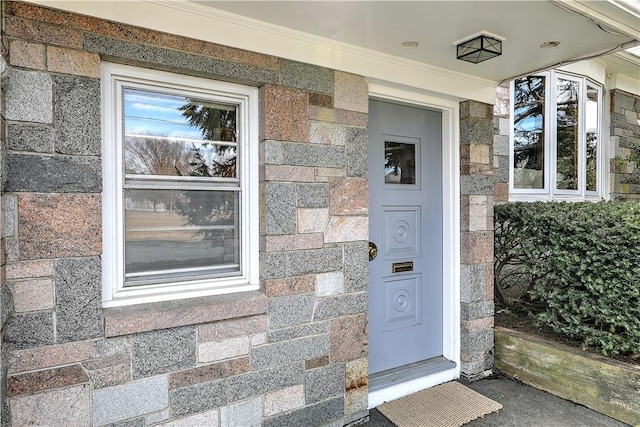 entrance to property featuring brick siding