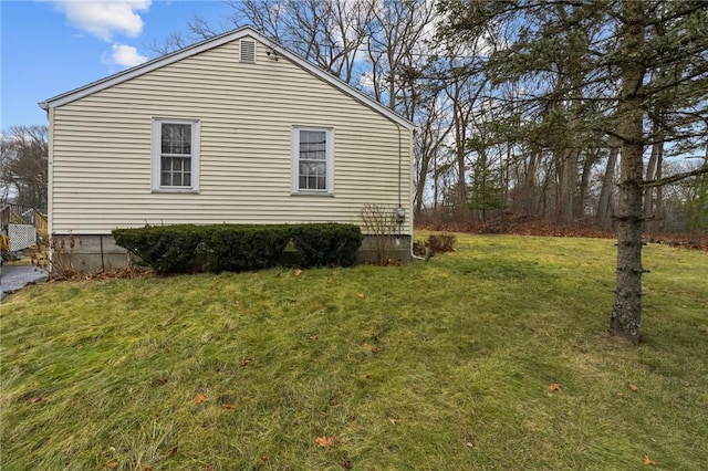 view of property exterior with a lawn