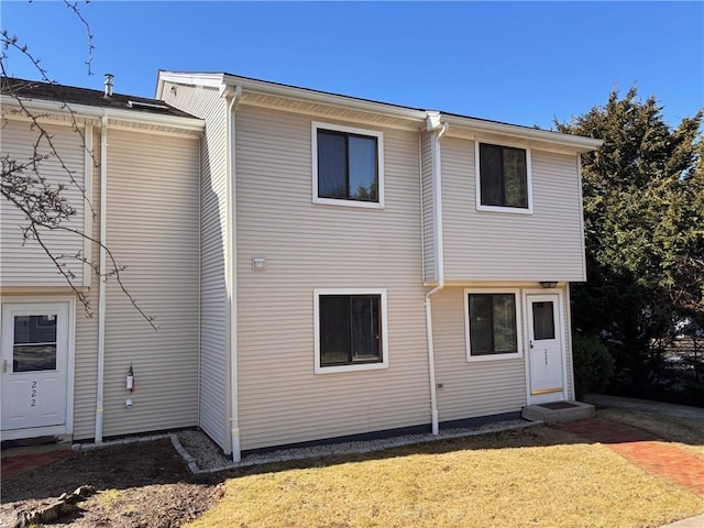 rear view of property with a yard