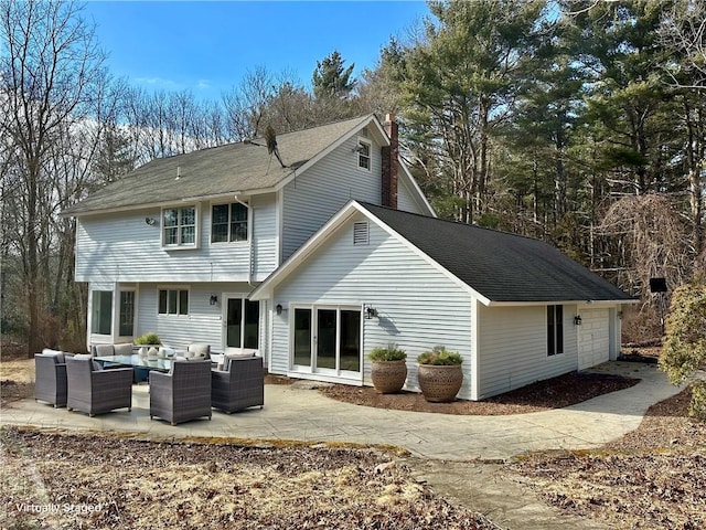 rear view of house featuring a patio area, an outdoor hangout area, a chimney, and roof with shingles