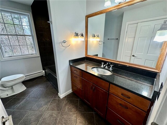 bathroom with toilet, vanity, baseboards, and a baseboard radiator