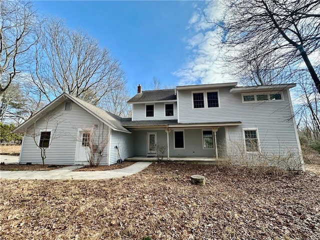 view of front of house with a porch and a chimney