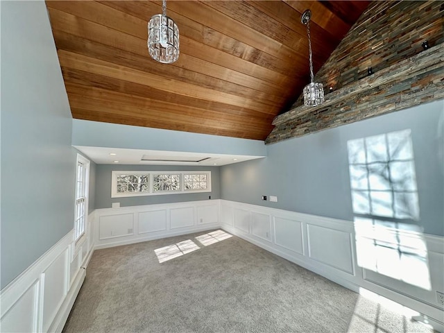 additional living space with wooden ceiling, carpet flooring, wainscoting, and vaulted ceiling