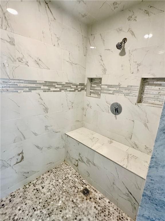 full bath featuring tiled shower