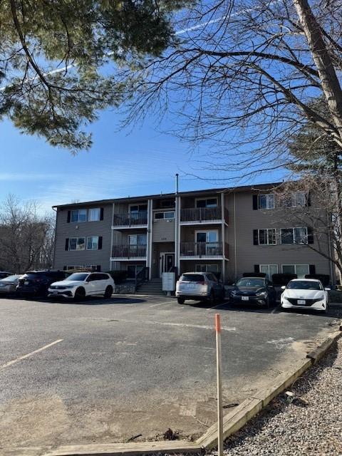 view of building exterior featuring uncovered parking