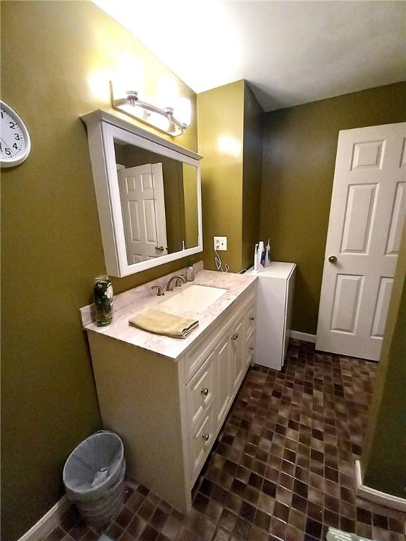 bathroom with vanity and baseboards