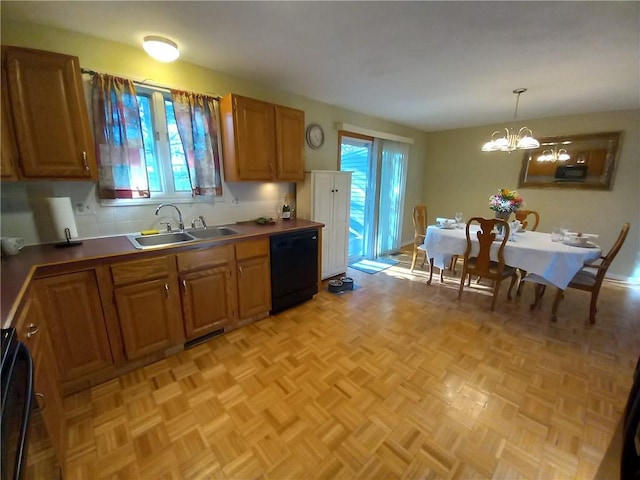 kitchen featuring decorative light fixtures, dishwasher, brown cabinets, a notable chandelier, and a sink