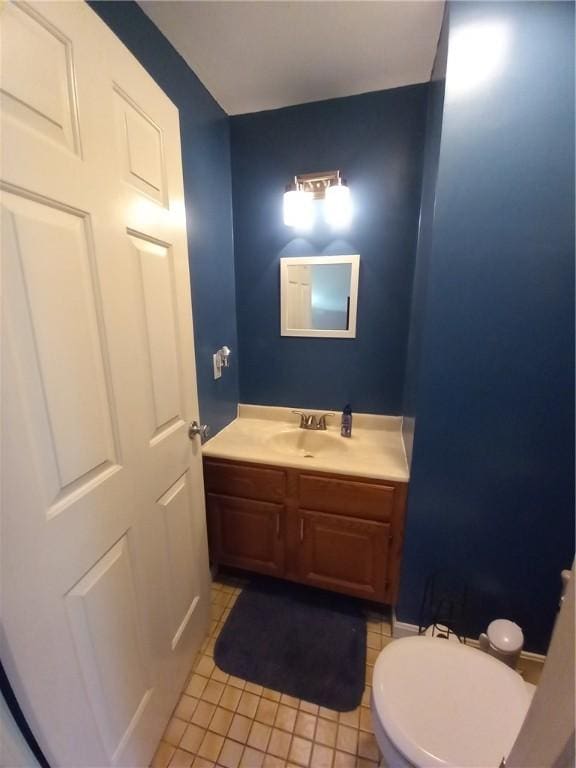 bathroom featuring tile patterned floors, toilet, and vanity