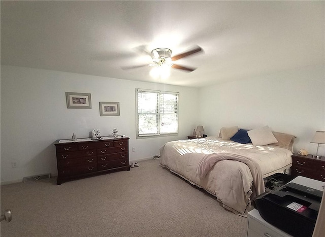 bedroom featuring visible vents, a ceiling fan, and carpet