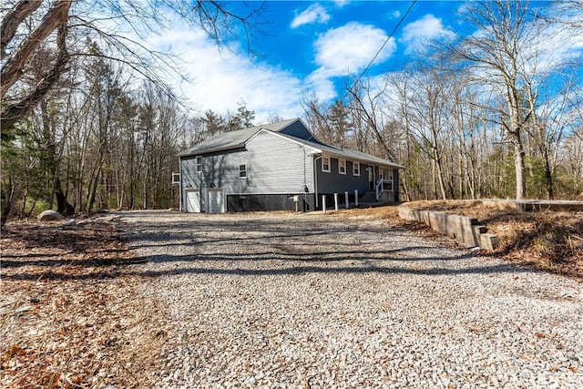 view of home's exterior with gravel driveway