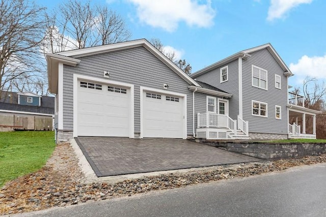 view of front of property with a front lawn, a garage, and driveway