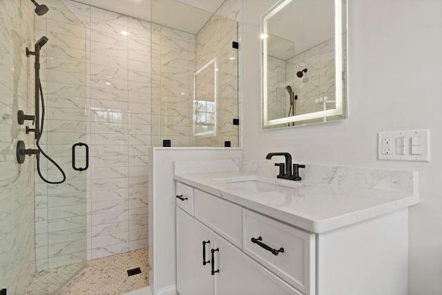 full bathroom with a stall shower and vanity