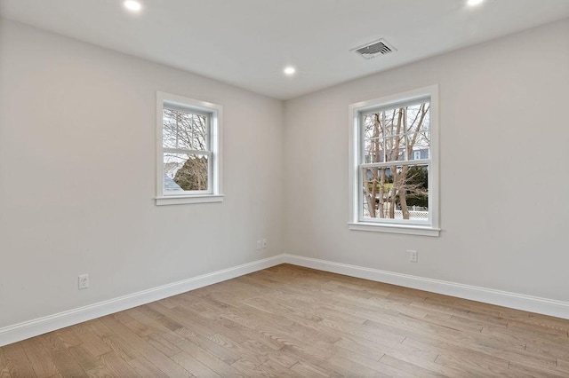 unfurnished room featuring visible vents, recessed lighting, baseboards, and light wood-type flooring