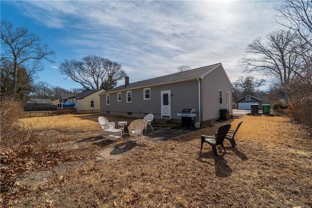 back of property with an outbuilding and a chimney