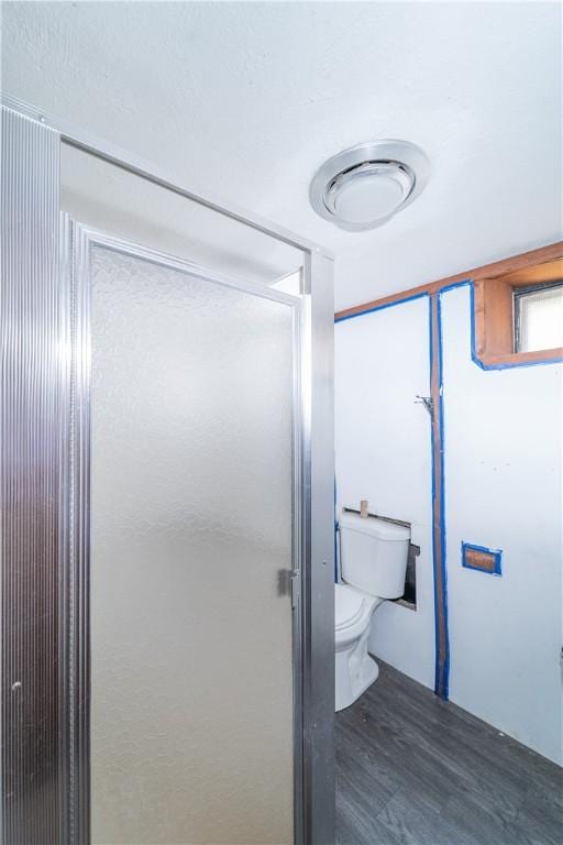 bathroom featuring toilet and wood finished floors