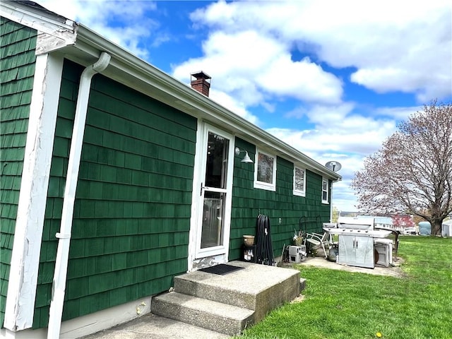 exterior space with a yard and a chimney