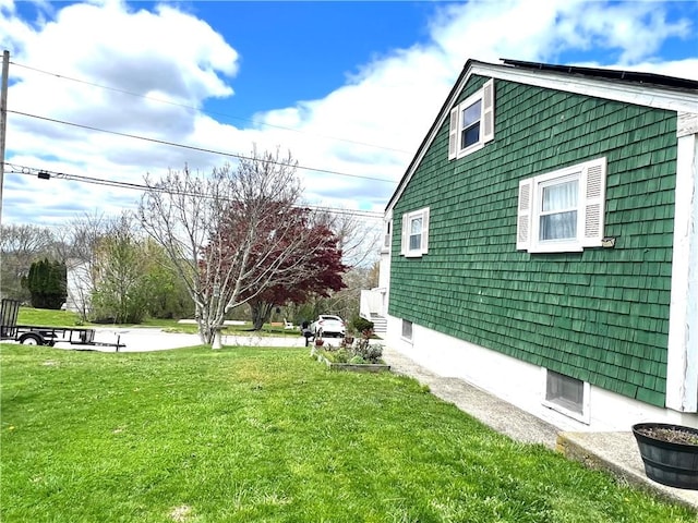 view of side of home featuring a lawn