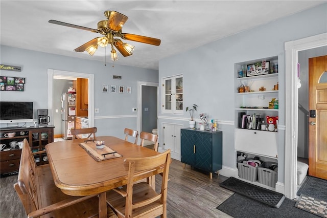 dining space featuring a ceiling fan and wood finished floors