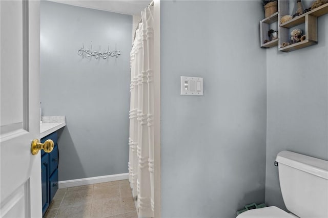 full bathroom with vanity, toilet, baseboards, and tile patterned flooring