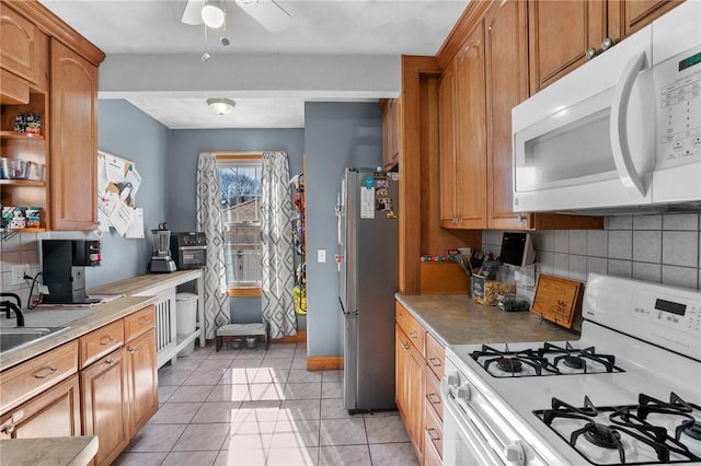 kitchen with backsplash, white appliances, brown cabinetry, light tile patterned floors, and baseboards