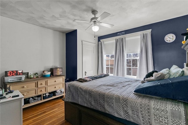 bedroom with ceiling fan and wood finished floors