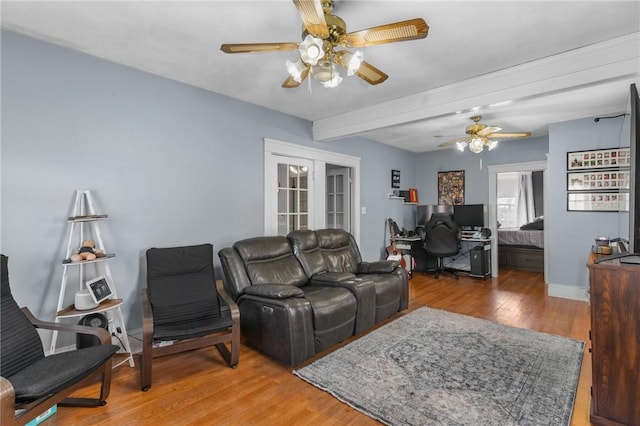 living room featuring wood finished floors, baseboards, beam ceiling, ceiling fan, and french doors