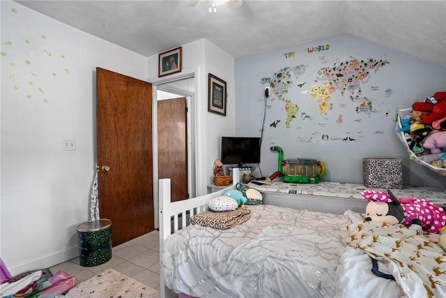 tiled bedroom with baseboards, lofted ceiling, and ceiling fan