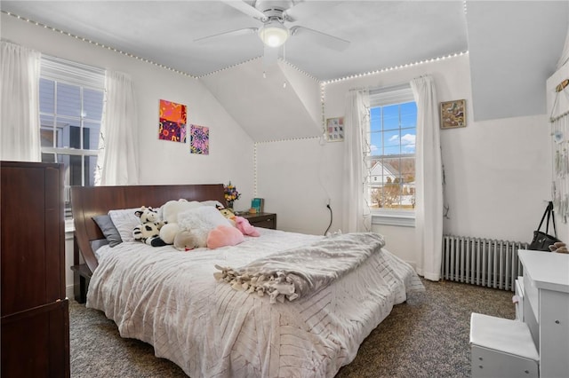 carpeted bedroom with lofted ceiling, radiator, and ceiling fan