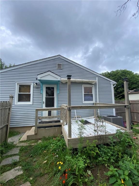 back of house featuring a wooden deck, central AC unit, and fence