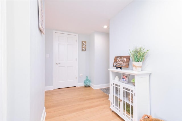 hall featuring recessed lighting, light wood-style floors, and baseboards