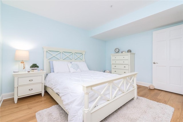 bedroom featuring baseboards and light wood-type flooring