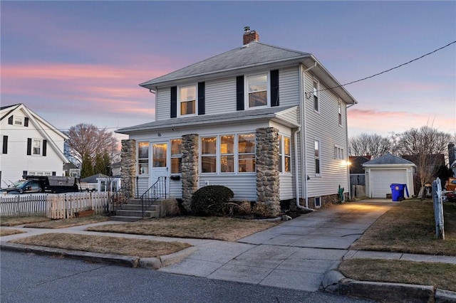 view of front of house with driveway, a detached garage, fence, an outdoor structure, and a chimney