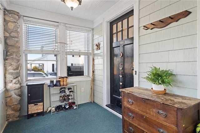 interior space featuring crown molding and carpet floors