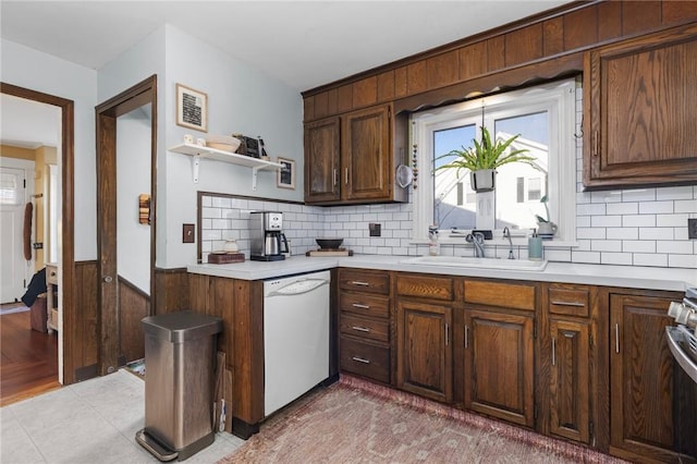 kitchen with visible vents, dishwasher, light countertops, wainscoting, and a sink