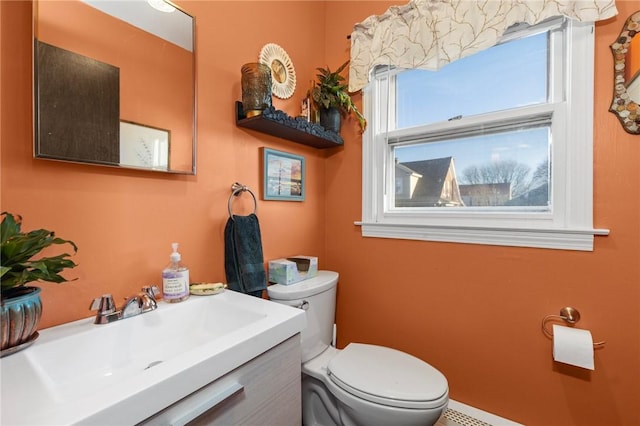 half bathroom with vanity and toilet