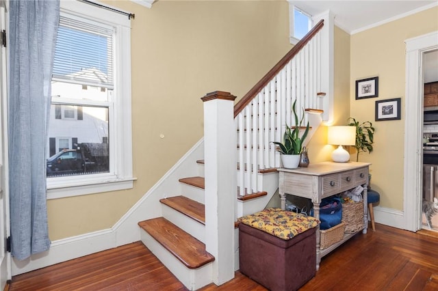 stairs featuring a healthy amount of sunlight, baseboards, and ornamental molding