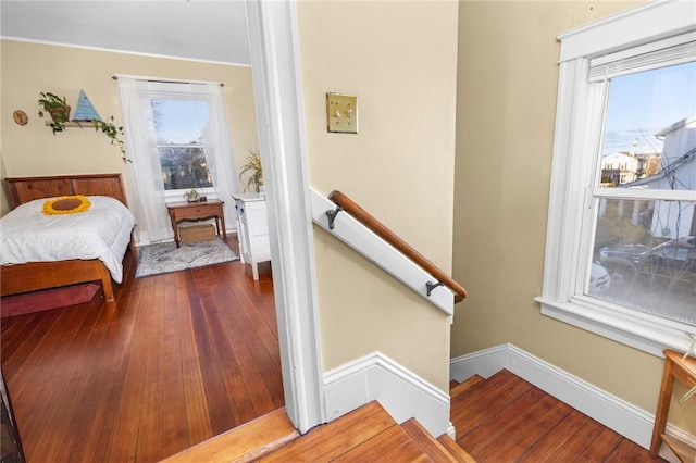 bedroom with hardwood / wood-style floors and baseboards