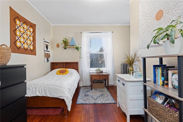 bedroom featuring dark wood-style floors and crown molding