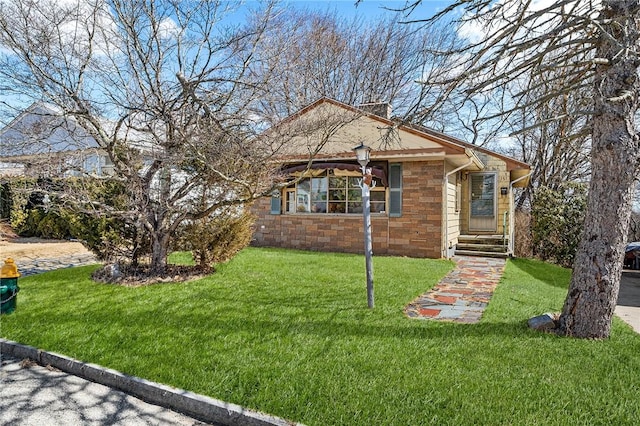 view of front of property with stone siding and a front lawn