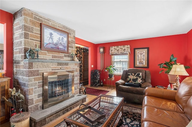 living room with a fireplace and wood finished floors